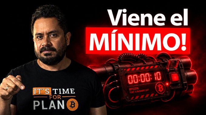 The image features an advertisement for Bitcoin, with a man standing next to a bomb that has the text "Vieje el minimo!" written above it. The man appears to be wearing a black t-shirt with the Bitcoin logo on it. The scene suggests that the Bitcoin advertisement is promoting the idea of investing in Bitcoins as a way to minimize risks and potentially earn money.