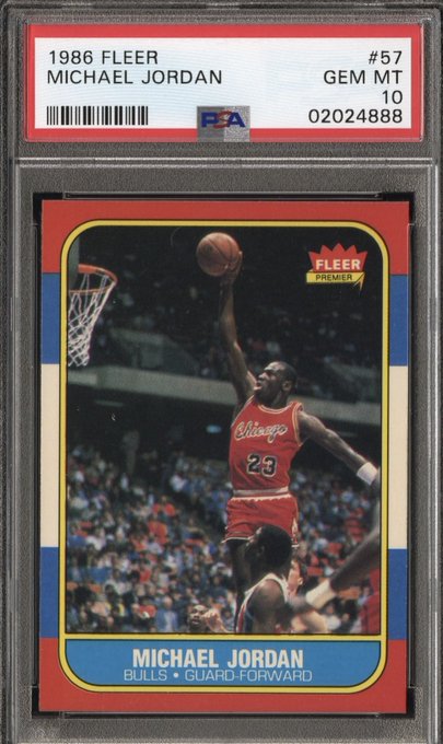 A PSA-graded GEM MT 10 1986 Fleer #57 Michael Jordan rookie basketball card shows Jordan mid-dunk in a red Chicago jersey.