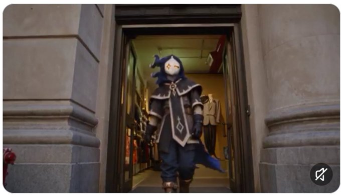 A person in a penguin costume with a hood and decorative outfit stands in the doorway of a building.