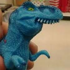 A hand holding a small blue dinosaur toy figure, which appears to be a knock-off or 'fake' version of a popular dinosaur toy.