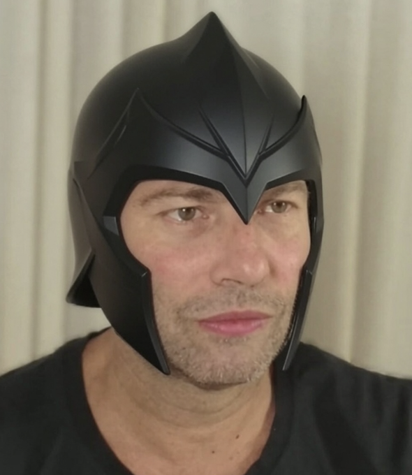 A man wearing a black helmet, possibly inspired by a superhero or warrior design, looking directly at the camera.