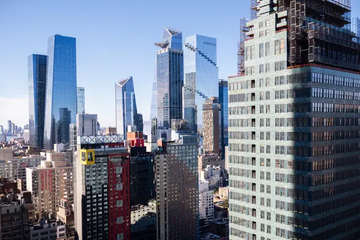 A panoramic view of the Midtown Manhattan skyline featuring modern glass skyscrapers and dense urban architecture, with no visible text or branding.

The image of New York City's financial district skyscrapers provides a fitting backdrop for the post's message about financial innovation, specifically the mention of tokenized offerings and the company @coinage_media pioneering a Tokenized Co-op Offering.