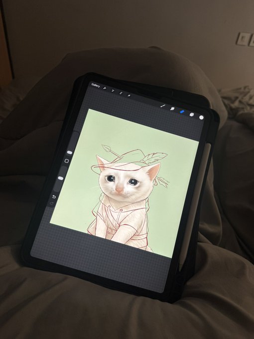 A tablet resting on a gray beanbag displays a digital artwork of a white cat dressed as Peter Pan, fitting the playful "Lilstars" NFT teaser shown in the post.