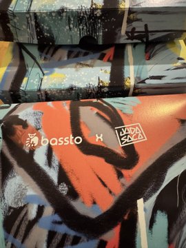 A piece of urban street art featuring bold black, red, blue, and white brushstrokes, signed with 'bassta' and 'KDA 21' tags.