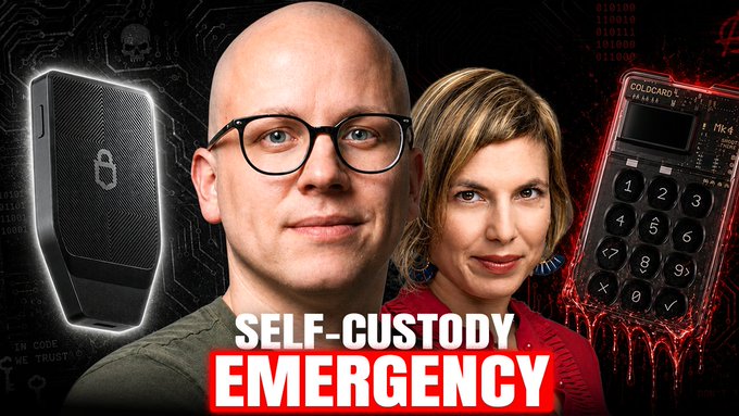 A YouTube thumbnail featuring a bald man with glasses and a woman, with "SELF-CUSTODY EMERGENCY" text displayed alongside a Trezor hardware wallet, a Coldcard Mk4 device, and the title referencing Trezor CTO Tomáš Sušánka discussing the Coldcard hack.