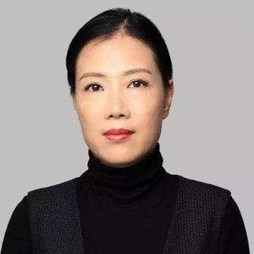 A professional headshot shows an Asian woman with dark hair pulled back, wearing red lipstick and a black turtleneck under a dark gray vest against a plain light gray background.