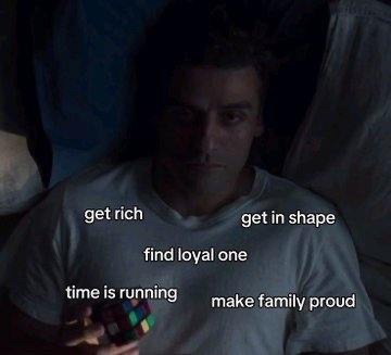 A man lies in bed in a dark room, looking at his phone, with overlaid text reading 'get rich', 'get in shape', 'find loyal one', 'time is running', and 'make family proud'.