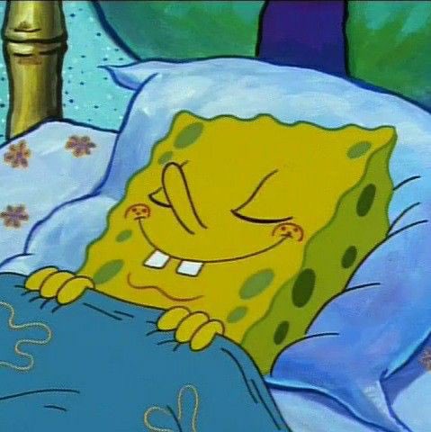 SpongeBob SquarePants sleeping peacefully under a blue blanket, smiling contentedly with his eyes closed.