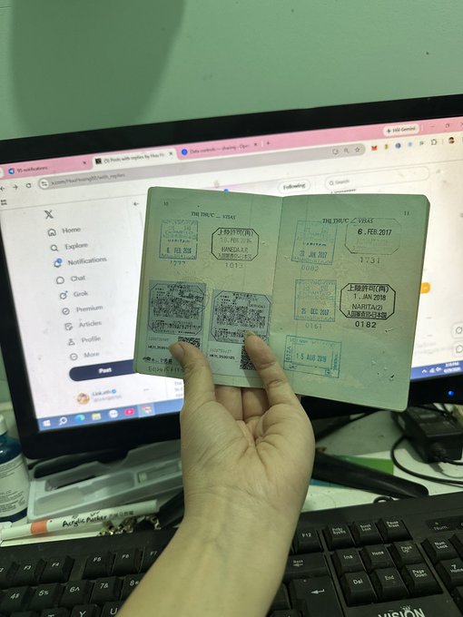 A hand holds open a TRAC/VISIT travel passport filled with entry/exit stamps dated February 2017 (Feb 1-8, numbered 1013 and 0182), photographed against a laptop screen showing the X platform. The worn, stamp-filled passport visually represents the "yap trend" era mentioned in the post—the period of frequent travel before it suddenly stopped, symbolizing the emptiness felt when the momentum of movement and progress came to a halt.