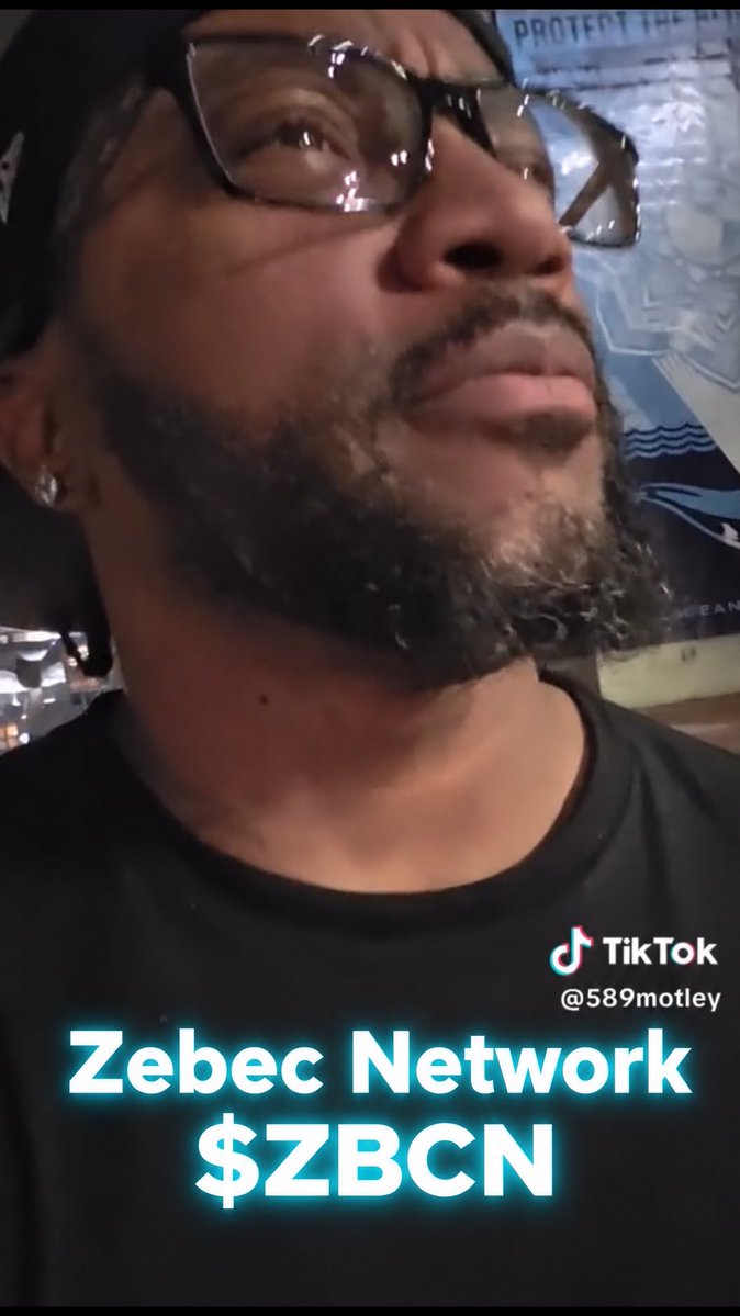 A TikTok screenshot from user @589motley featuring a man wearing glasses and a black shirt, with overlaid text promoting 'Zebec Network $ZBCN'.