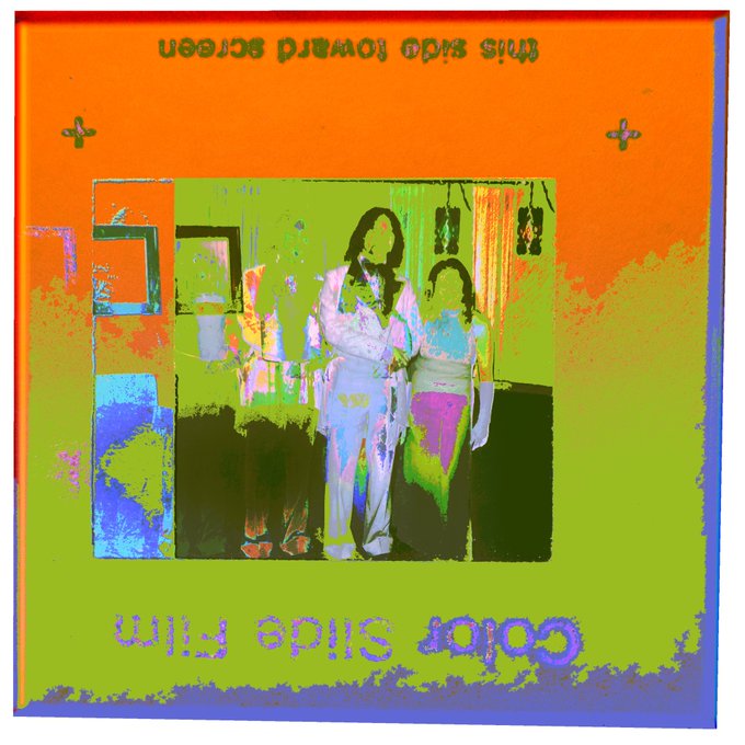 A stylized, high-contrast album cover with an orange and green color scheme displays the reversed text 'DOLLS AND ROSE' and features three figures standing in a room.