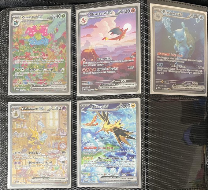 A collection of five Pokémon TCG cards displayed in a binder, featuring Venusaur ex, Charizard ex, Blastoise ex, Alakazam ex, and Zapdos ex, all with high HP values (340, 330, 330, 310, and 200 respectively).