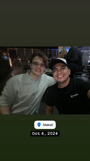 Two smiling men take a selfie together in a dimly lit restaurant or bar, with a Snapchat location tag indicating 'Makati' and 'Oct 4, 2024' displayed at the bottom.
