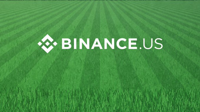 The image features the Binance.US logo displayed on a freshly mowed baseball field, with the caption playing on the "touch grass" meme — a crypto slang term referring to stepping away from screens. The listed tickers ($SOL, $XRP, $ZEC, $BTC, $ETH) suggest the post is inviting users to share moments when they took a break from trading on the Binance.US platform.