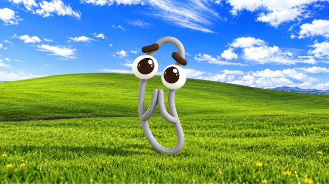 The classic Windows XP 'Bliss' wallpaper featuring rolling green hills and a blue sky, with a Clippy paperclip cartoon character superimposed in the center.