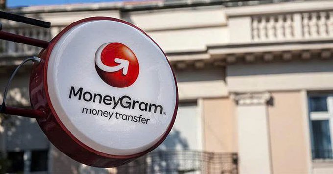 A circular MoneyGram money transfer sign mounted outside a building.