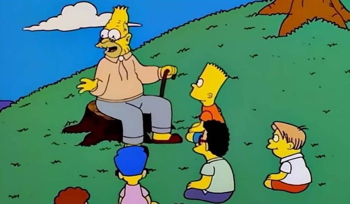 A scene from The Simpsons featuring Grandpa Simpson sitting on a tree stump holding a cane, telling a story to Bart, Milhouse, and other children on a grassy hill.