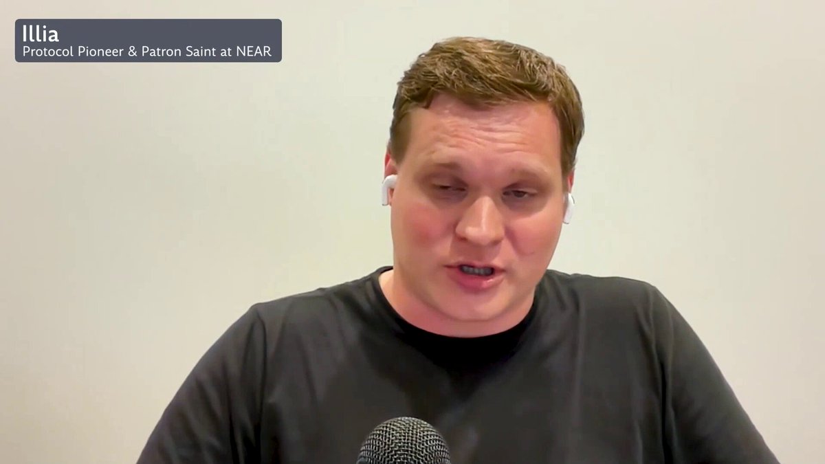 The image shows a man wearing a black shirt, sitting at a desk with a microphone in front of him. He appears to be talking into the microphone or having his voice recorded. The background features a white wall, which contrasts with the man's dark clothing. There is also text visible on the image that reads "code is law until the code is wrong - and then we actually want real law" and "NEAR is now running AI anomaly detection on cross-chain deposits in real time". This suggests that the man might be discussing a recent incident or an ongoing investigation related to coding errors, data breaches, or other technological issues.