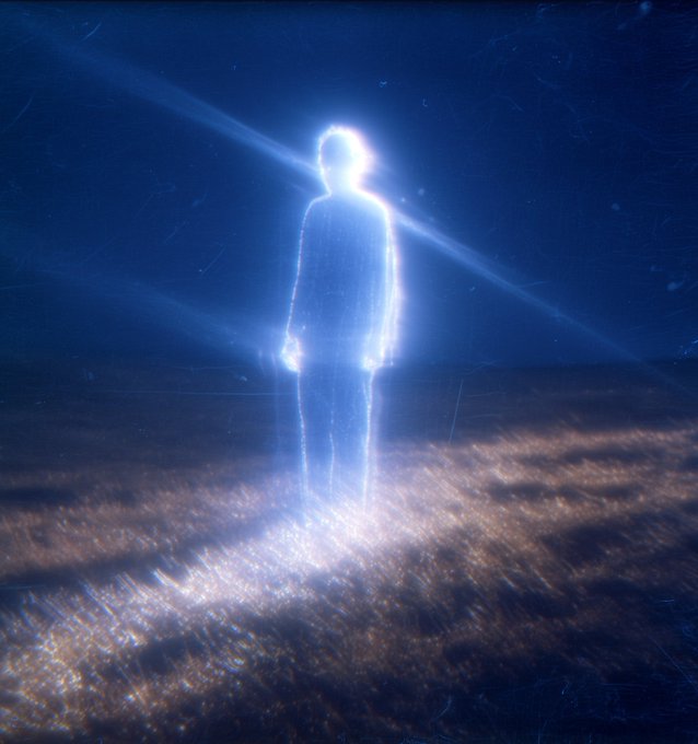 A glowing, ethereal blue silhouette of a person stands in a dark, grassy field illuminated by a central beam of light, resembling a celestial or supernatural figure.