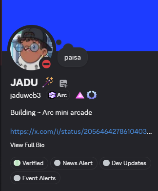 The image features a screen displaying information about a Minecraft-themed social media platform called "@Arcminiarcade". There are two people present in this virtual space, one of whom has a profile picture that reads "JADUWWE3 JADUWWE 3". Another person's profile picture shows them as a cartoon character. 

The post says there have been 10 days since they built and shipped the @Arcminiarcade on the @arc Testnet, but the developer is still waiting for the Builder role in the ARC Discord. Meanwhile, an event alert indicates that the user has notified the project team about the status of the game development updates.