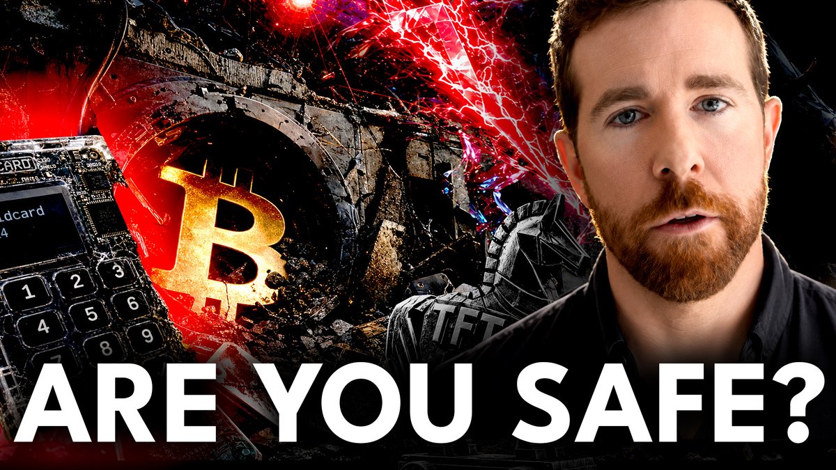 A YouTube thumbnail featuring a bearded man on the right alongside a circuit board device, a golden Bitcoin logo, and dramatic red shattered effects, with bold text reading "ARE YOU SAFE?" — directly promoting a discussion about the Coldcard Bitcoin hardware wallet vulnerability and how to protect one's coins.