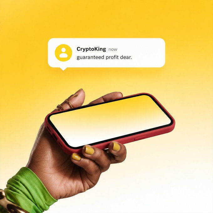 A hand with yellow-painted nails holds a smartphone displaying a message from "CryptoKing" promising "guaranteed profit dear," illustrating the post's warning that unsolicited messages offering easy money are actually targeting the recipient as the real opportunity.