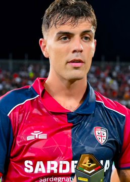 A young male soccer player with short dark hair, wearing a red and navy Cagliari jersey featuring "SARDEGNA" text and the team's crest, stands on the pitch. The image relates to the accompanying post, which identifies the player as Daniel Maldini, the son of legendary defender Paolo Maldini, following his recent DUI charge and car accident.