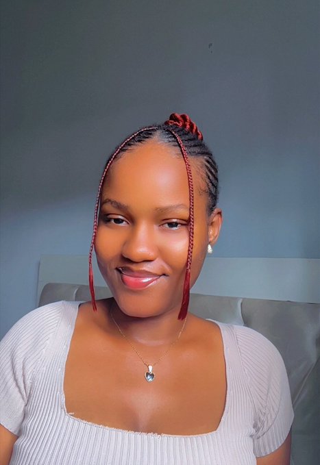 The image features a woman with red braids wearing a white shirt. She has a smile on her face, indicating she is happy or content. The caption of the image reads "Day 35 of smiling until @ritualnet Mainnet I’ll be trying out some dapps today, drop yours in the comment for testing". This suggests that the woman might have been participating in an online challenge related to dapp usage and is excited about sharing her experience with others.