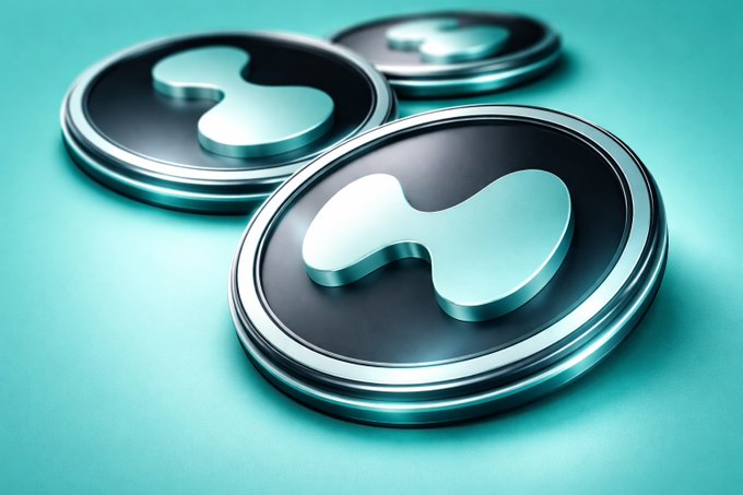 The main focus of the image is two silver colored coins placed on a green surface against a blue background. Both coins feature a unique wavy design, with one coin positioned above the other. This suggests that they might be part of a special collection or artistic display. However, it is not clear whether these coins are directly related to any financial news or events like ETF speculation being pushed by Hyper LiquidX. The image's focus seems more on showcasing the coins' aesthetic appeal than analyzing market trends and speculation.