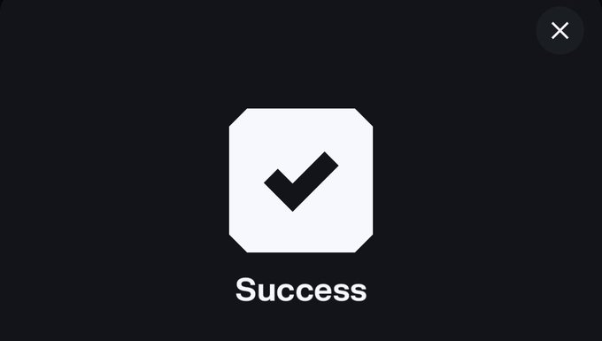 A dark screen displaying a white checkmark icon with the text 'Success' below it, featuring an X close button in the top right corner.