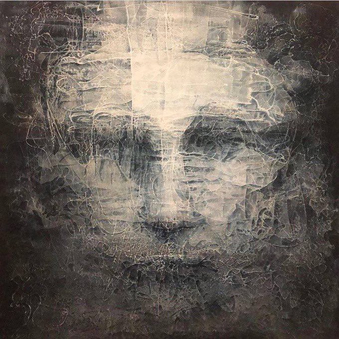 A dark, abstract, textured artwork featuring a ghostly face emerging from swirling, scratched, monochromatic patterns in shades of gray and beige.