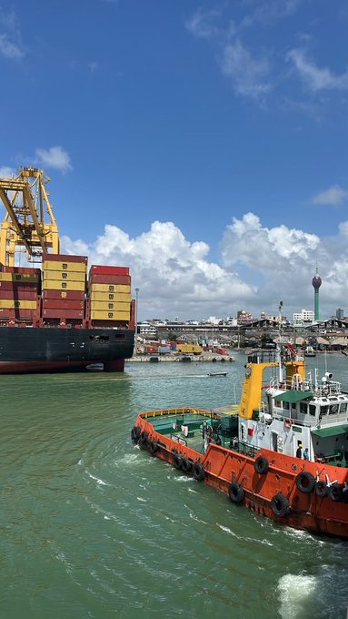 A container ship stacked with colorful shipping containers sits in a harbor under a partly cloudy sky, while an orange tugboat maneuvers nearby in front of a port city skyline featuring a tall communications tower.

The harbor scene of international shipping and trade serves as a metaphor for global commerce and cross-border earnings, reinforcing the idea that financial opportunities—like goods moving across oceans—are not limited by where you live.