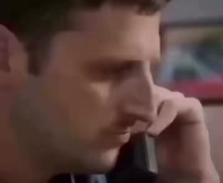 The image shows a man talking on his cell phone while sitting down. He appears to be looking down at something or someone outside of the frame. The caption below the photo reads "When bro finds out, the sergeant is a dog holder too". This phrase suggests that there might have been an incident involving a dog in their relationship, and the man is discussing it with someone else on his phone.