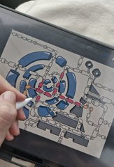 A close-up of a hand holding a white stylus over a drawing of Spider-Man on a tablet, with the character breaking through chains within a web-covered background.