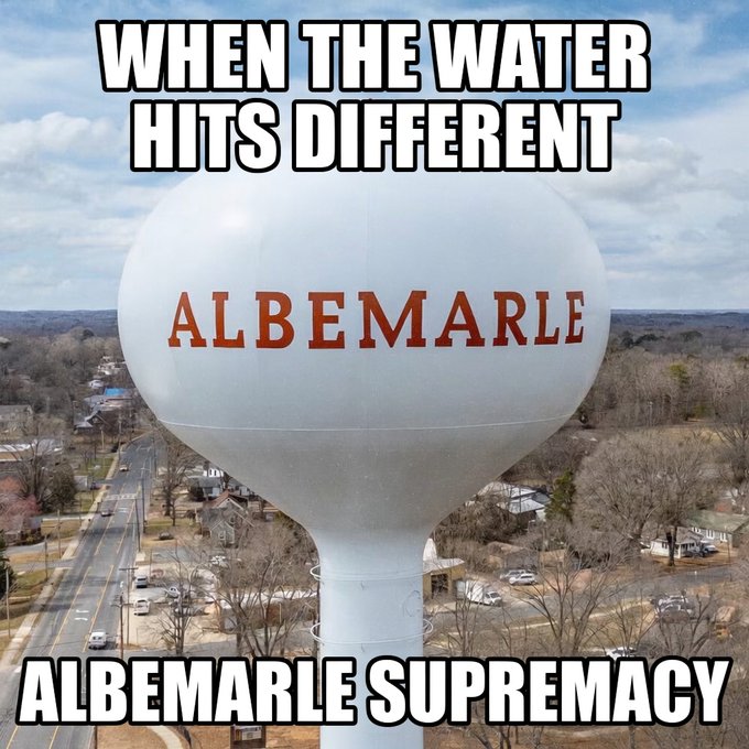 An aerial photograph of a white water tower labeled 'ALBEMARLE' is overlaid with meme-style text reading 'WHEN THE WATER HITS DIFFERENT' and 'ALBEMARLE SUPREMACY'.