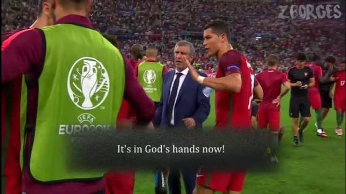 The image captures a moment from the Euro 2016 final, showing Portugal's Cristiano Ronaldo speaking with manager Fernando Santos, with the caption "It's in God's hands now!" displayed on screen, suggesting they are leaving their fate to chance (🤞) as they hope for the best outcome.