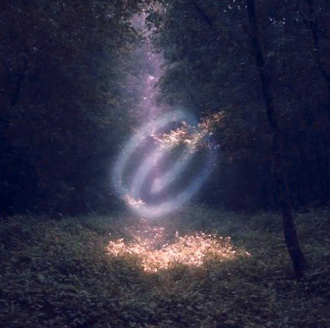 A surreal forest scene depicts a glowing cosmic galaxy emerging from the ground, framed by dark trees as a beam of starlight streams down from above. This visualizes "touching grass" by portraying a mystical, otherworldly encounter with nature—where simply stepping outside reveals an entire universe hidden in the soil.