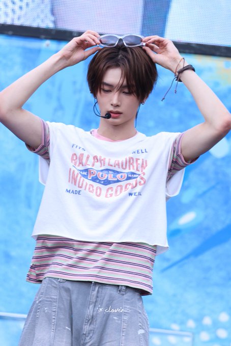 A young man named Zhou Anxin (周安信), also known as ALD1, poses with sunglasses on his head while wearing a Ralph Lauren Polo Indigo Goods t-shirt. The image aligns with the provided hashtags identifying him by his name and associated project, Alpha Drive One.