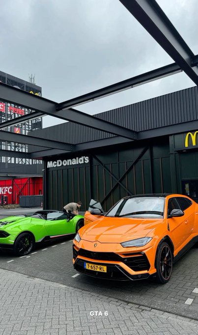 An orange Lamborghini Urus and a green sports car are parked outside a modern McDonald's location with visible 'McDonald's' signage and the golden arches logo, labeled 'GTA 6' at the bottom.