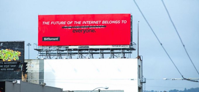 A large red billboard reads 'THE FUTURE OF THE INTERNET BELONGS TO THE HIGHEST BIDDER. everyone.' with the 'BitTorrent' logo in the bottom left corner.