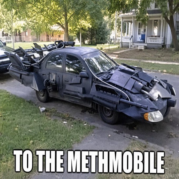 The image shows a black sedan modified with improvised armor, weaponry, and battle damage effects to resemble a dystopian Mad Max-style "war rig," parked on a residential street. Bold white text across the bottom reads "TO THE METHMOBILE," pairing with the caption "there will be signs when I make it… just don't ask" as a darkly humorous nod to a homemade post-apocalyptic vehicle project.