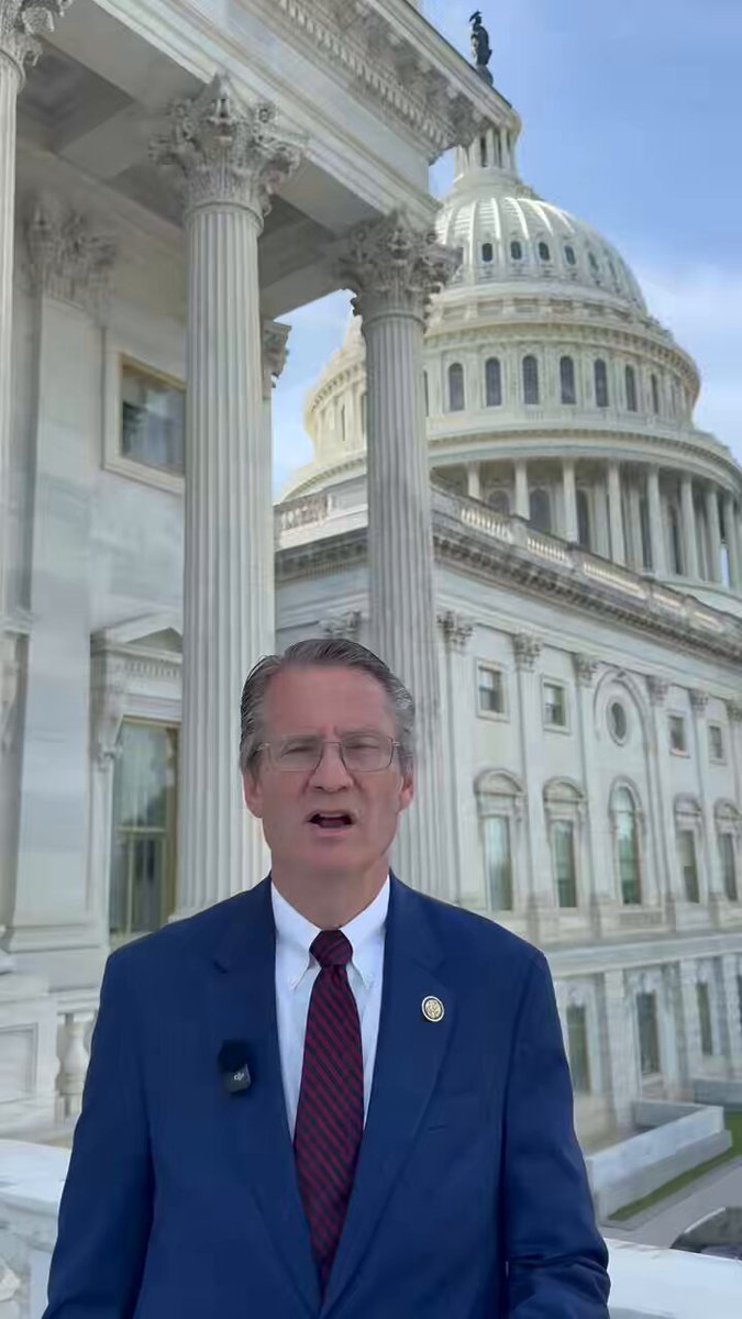 The image features a man dressed in a suit, standing in front of a large white building with columns, which appears to be the U.S. Capitol Building. The man is wearing glasses and has his mouth open as if he's speaking or making a statement. The caption below the photo reads "As the Chairman of DOGE, I am fighting to end waste, fraud, and abuse in Washington. Click the link below to see how we are fighting to keep more money in your dadgum pocket: burchett.house.gov/media/press-re". This suggests that the man is advocating for transparency and accountability within the government or perhaps discussing ways to increase public awareness about these issues.