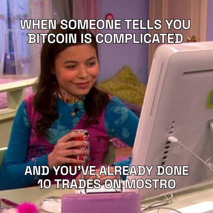 A meme featuring a young girl smiling at a computer monitor, with text reading 'WHEN SOMEONE TELLS YOU BITCOIN IS COMPLICATED AND YOU'VE ALREADY DONE 10 TRADES ON MOSTRO.'