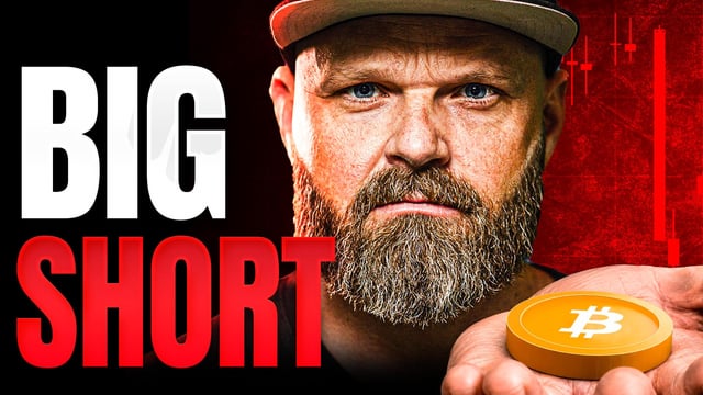 A thumbnail-style image featuring a bearded man in a cap against a red background with the bold text 'BIG SHORT' and a hand holding a Bitcoin coin.
