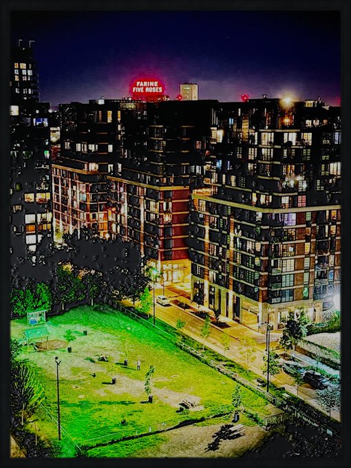 A nighttime HDR photograph of a city scene with a large illuminated apartment complex, a 'FARMING FIVE ROSES' neon sign on top, and a green-lit field in the foreground.