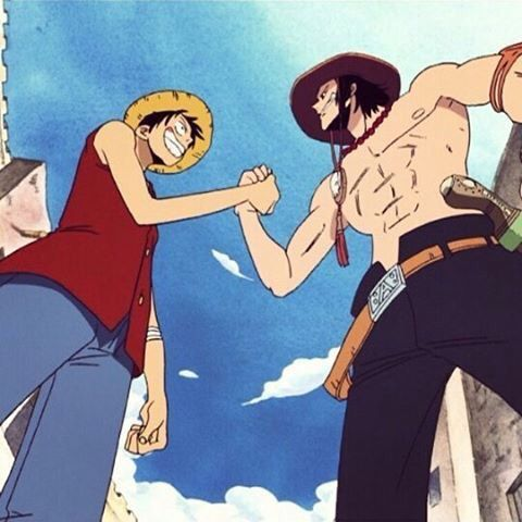Two anime characters, Monkey D. Luffy (in his red vest and straw hat) and Portgas D. Ace (shirtless with a cowboy hat), are shaking hands against a blue sky background.