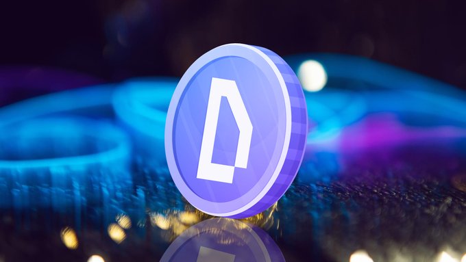 The image features a blue coin with a white "D" logo, placed on a reflective surface that appears to be a table or countertop. The background of the image is dark, which contrasts with the bright blue color of the coin. The text in the image reads "One game. One token. Every market." and "Focus on what is in the image and how it relates to the post", indicating that this image might be related to a discussion or analysis about the cryptocurrency market or blockchain technology.