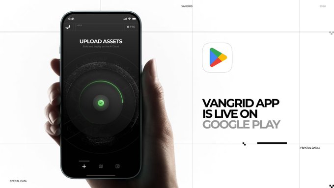A promotional graphic showing a hand holding a smartphone displaying the Vangrid app's 'UPLOAD ASSETS' screen, alongside the Google Play logo and text 'VANGRID APP IS LIVE ON GOOGLE PLAY'.