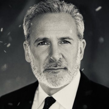 A black-and-white portrait shows a middle-aged man with gray hair and a salt-and-pepper beard, wearing a dark suit, white shirt, and dark tie, looking directly at the camera with a serious expression. The image appears to be of economist Peter Schiff, whose commentary in the accompanying post urges investors to sell Bitcoin ($BTC) in favor of gold following its rally past $72,000.