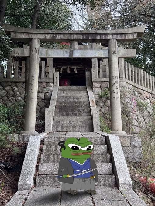 A Pepe the Frog character dressed as a samurai with a sword and traditional clothing stands at the base of stone steps leading up to a Japanese torii gate and shrine.